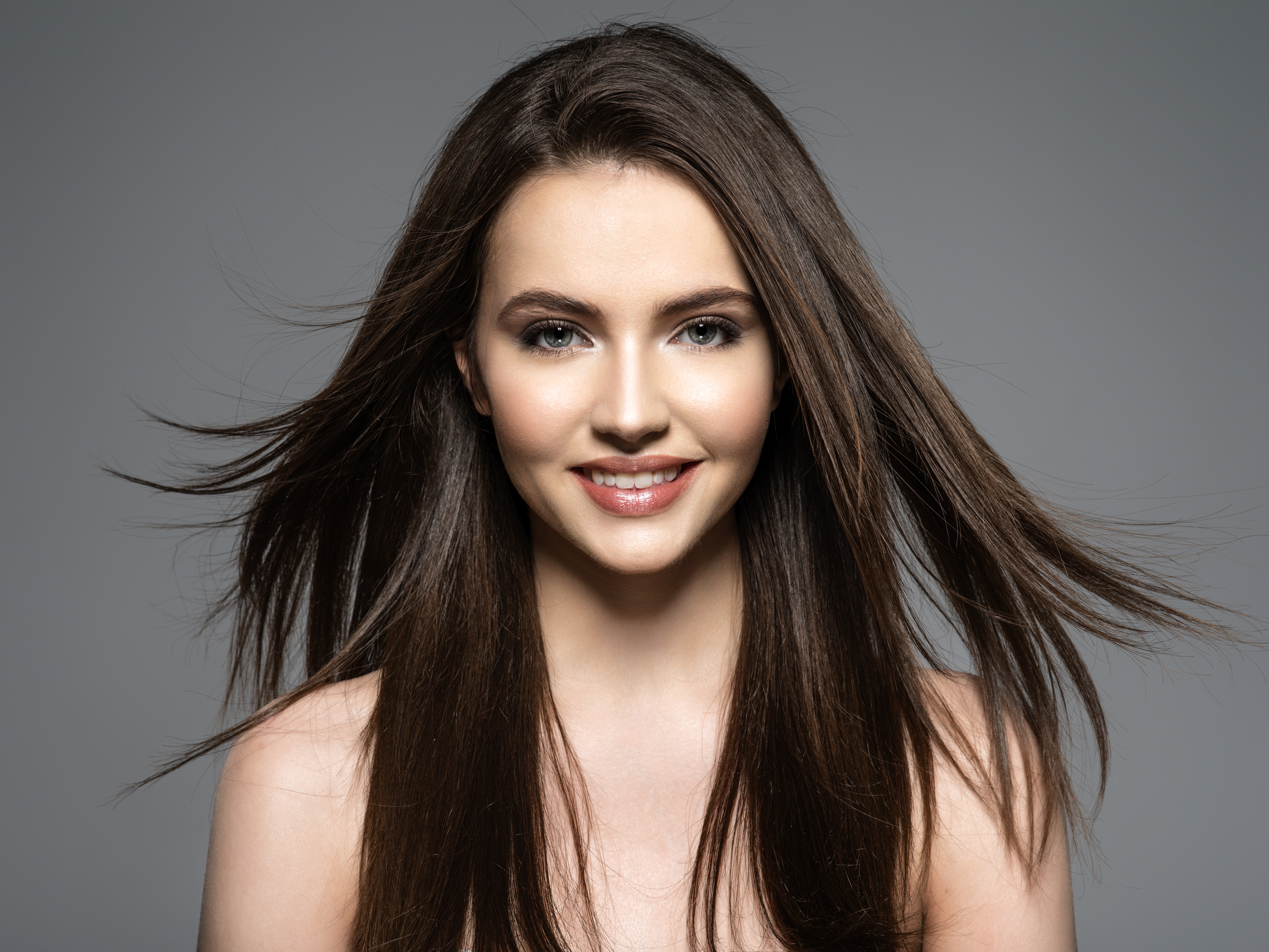 Brunette smiling woman with long brown hair.
